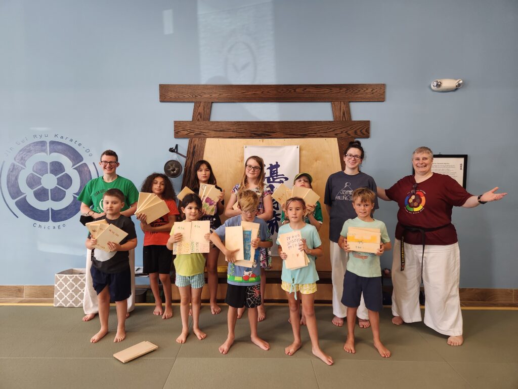 kids holding their broken boards after final camp performance